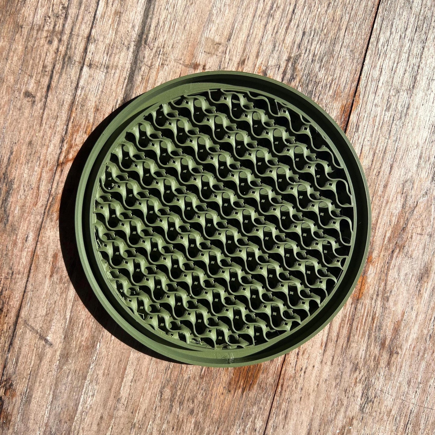 Top view of a gyroid drip tray in green, showing textured surface for water collection