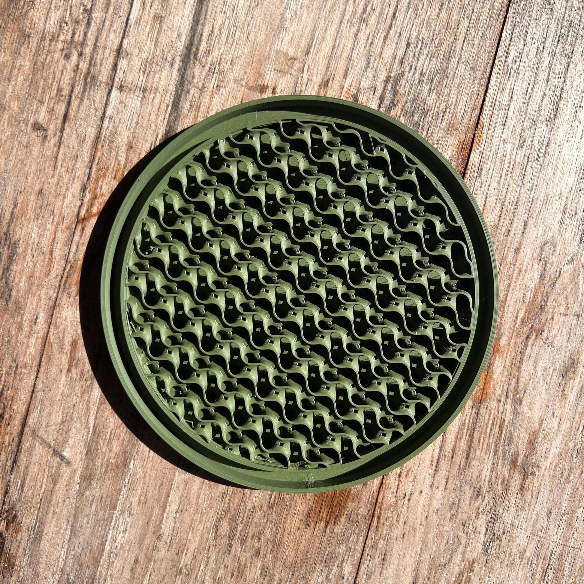 Top view of a gyroid drip tray in green, showing textured surface for water collection