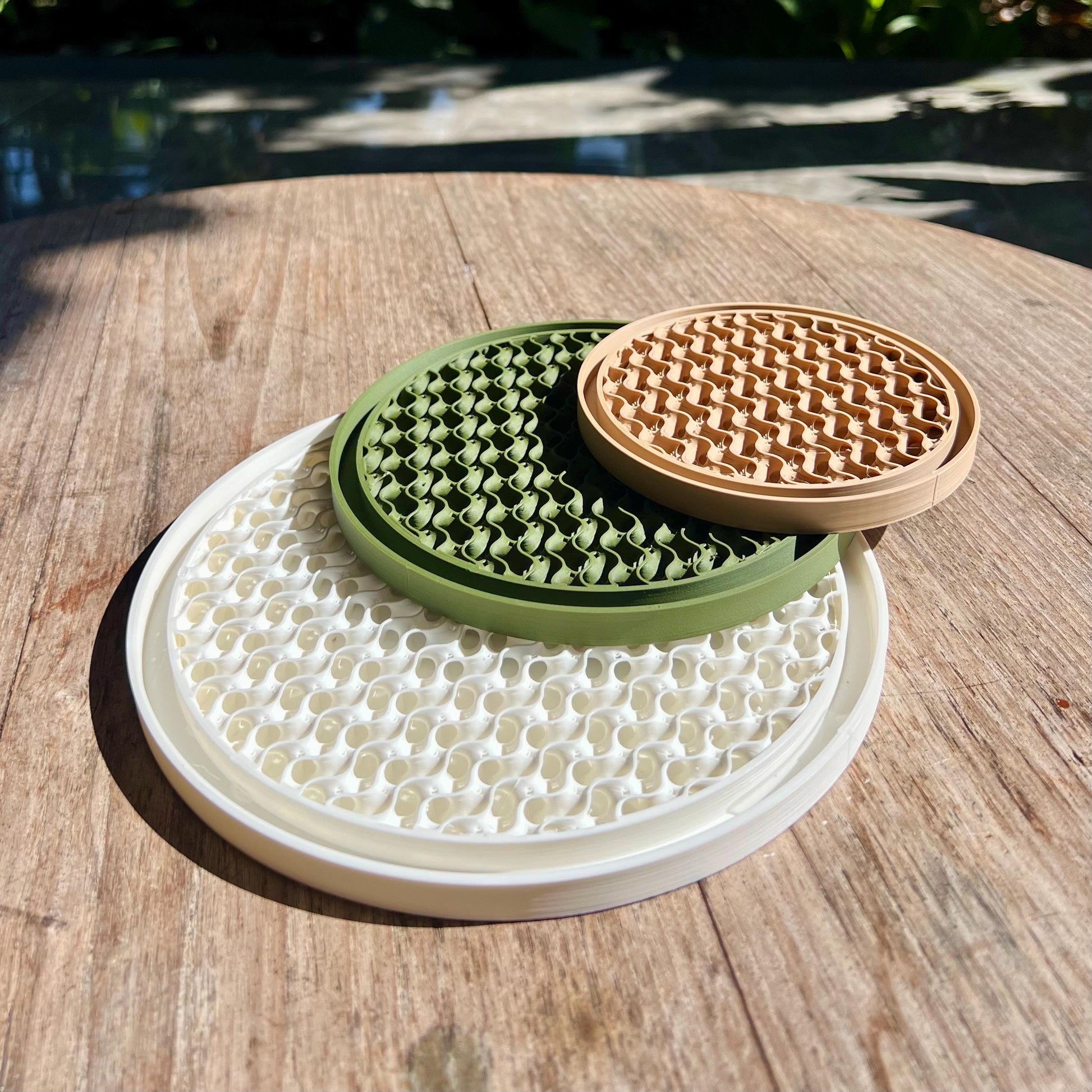 Stacked gyroid drip trays showing modular design and compatibility with different plant pots