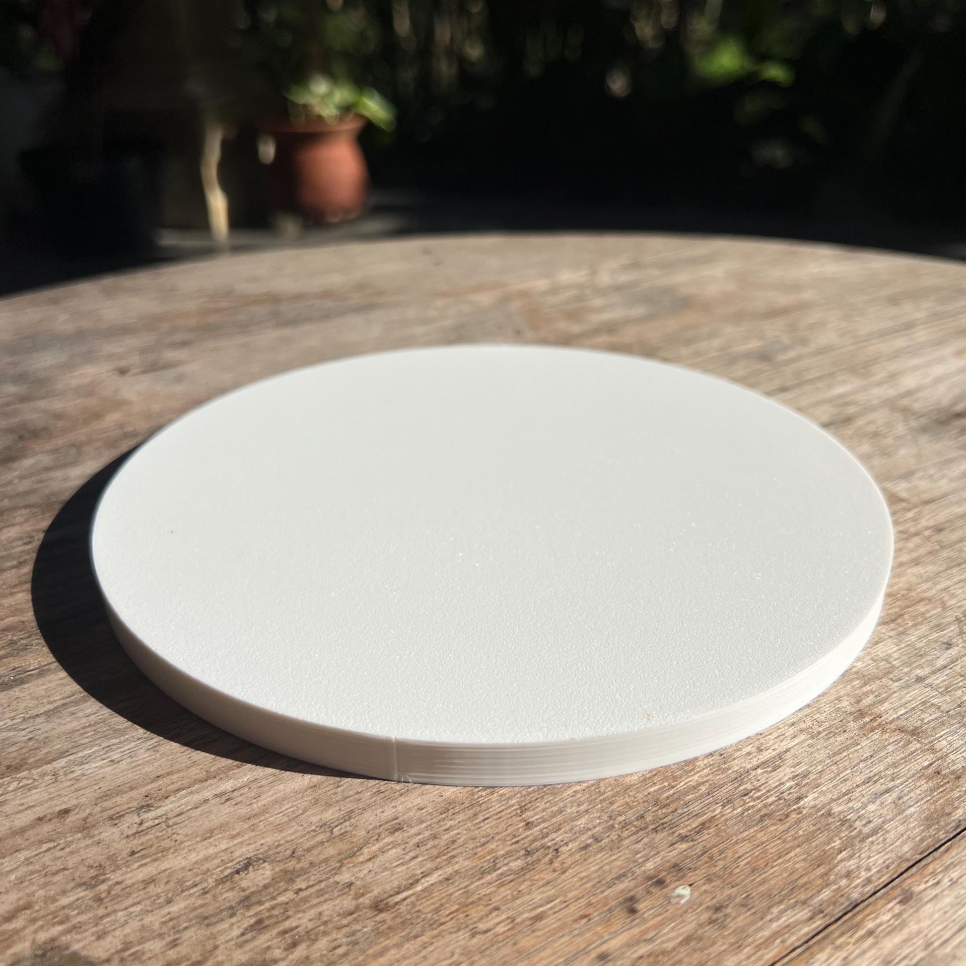 Flat underside of a gyroid drip tray with a textured base, designed to sit securely on indoor surfaces