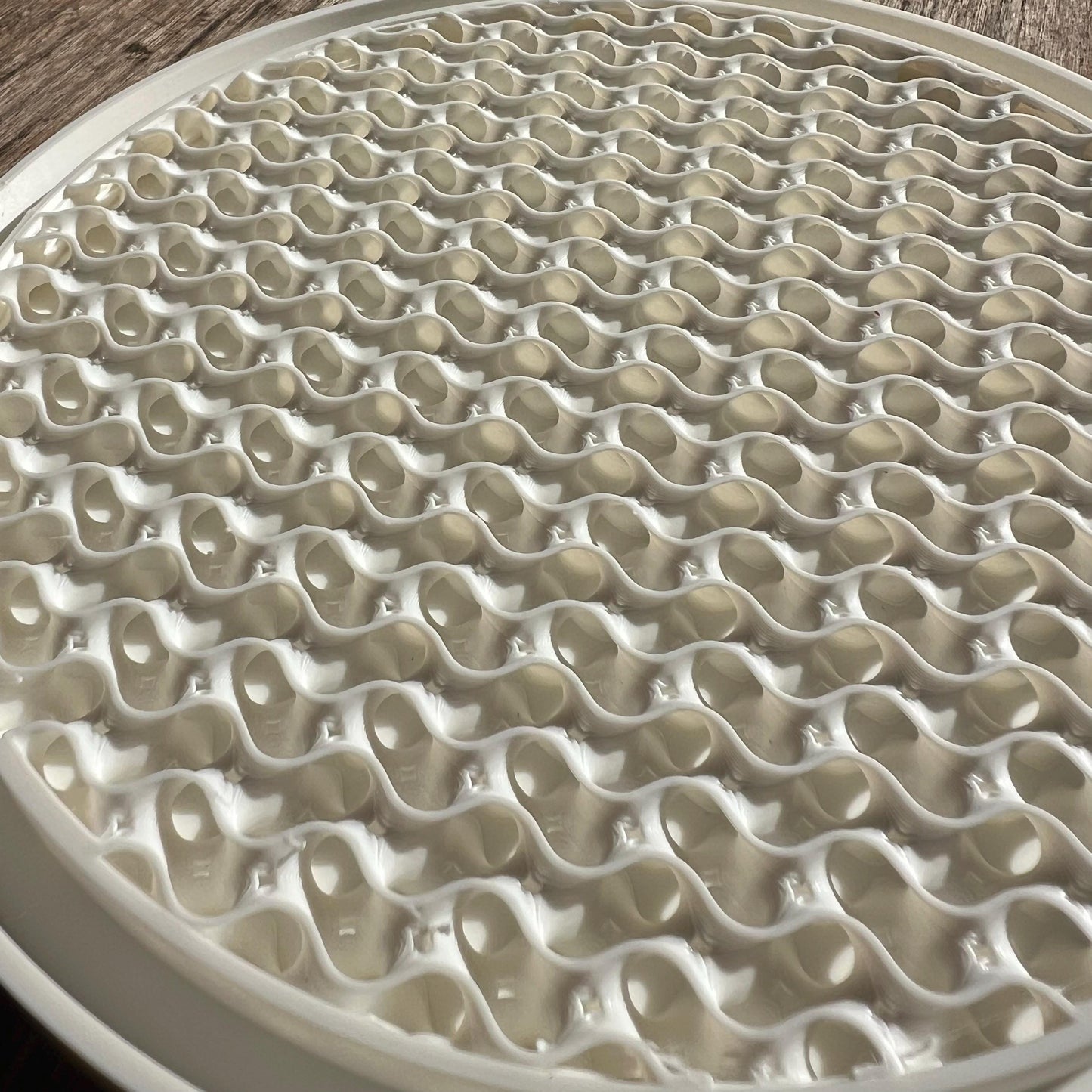 Close up of the gyroid pattern surface on a modular plant drip tray