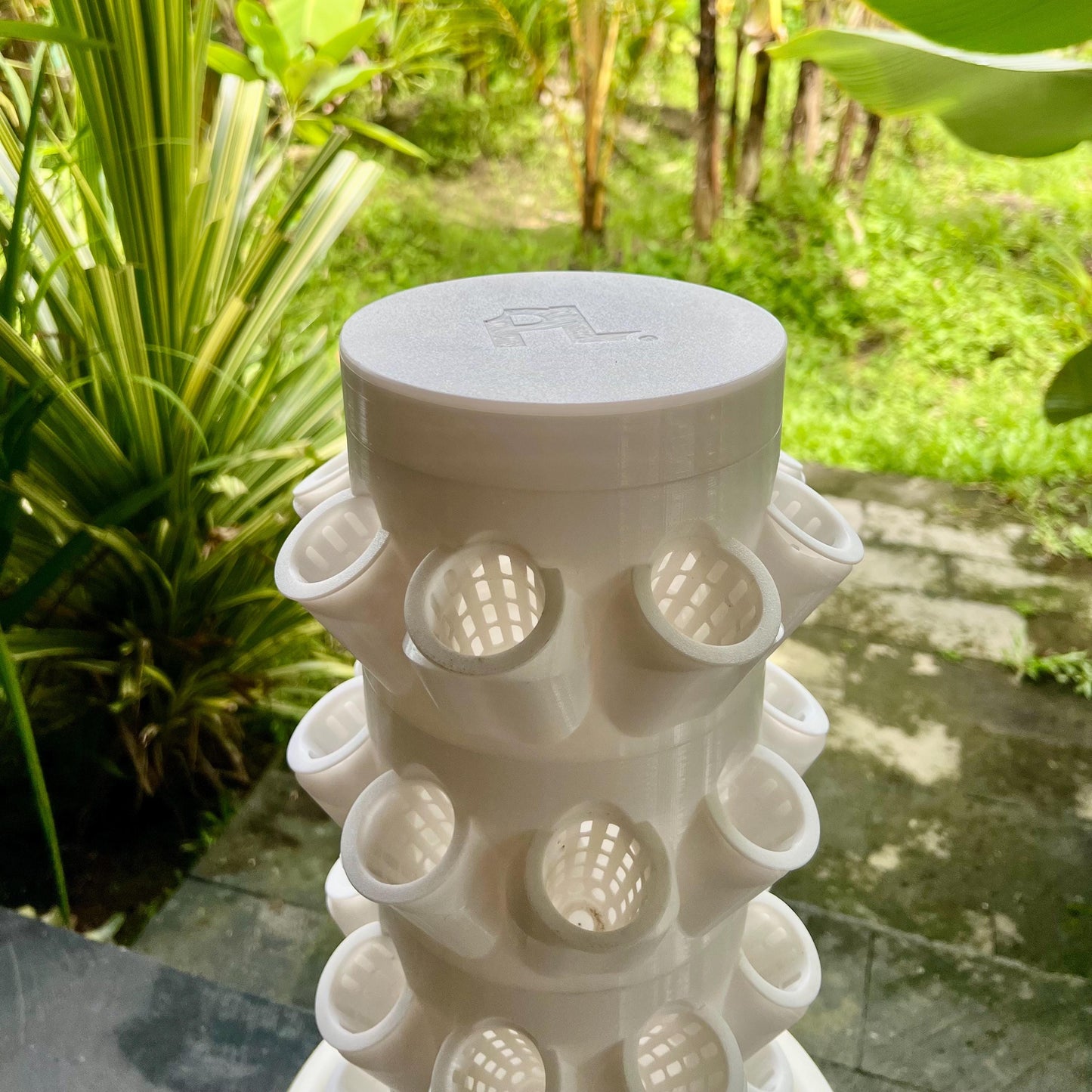 Top view of modular hydroponic grow tower with smooth capped reservoir, designed for efficient water circulation