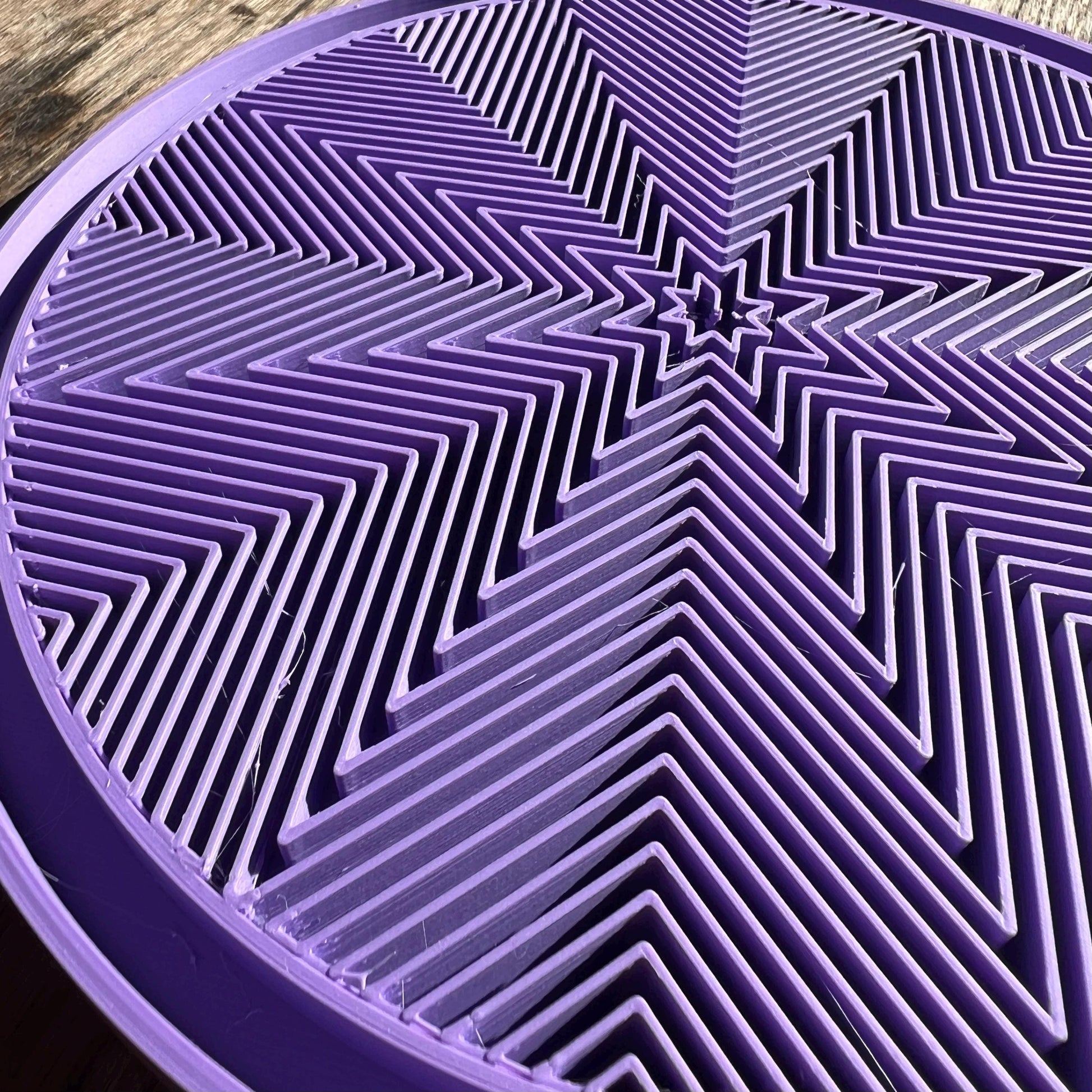 Close up of the star pattern surface on a modular plant drip tray