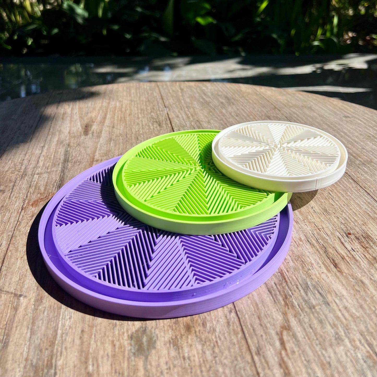 Stacked star pattern drip trays showing modular design and compatibility with different plant pots
