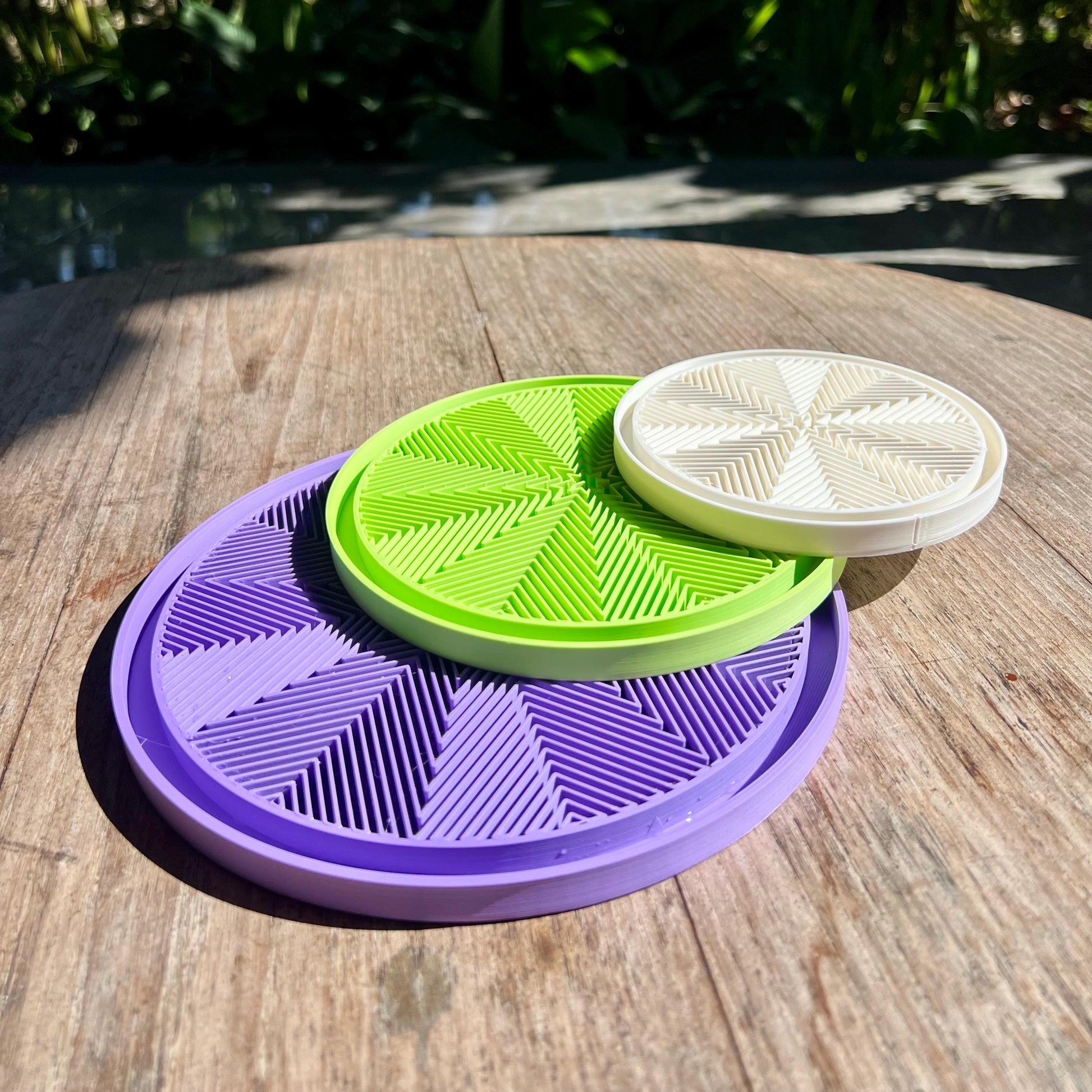 Stacked star pattern drip trays showing modular design and compatibility with different plant pots