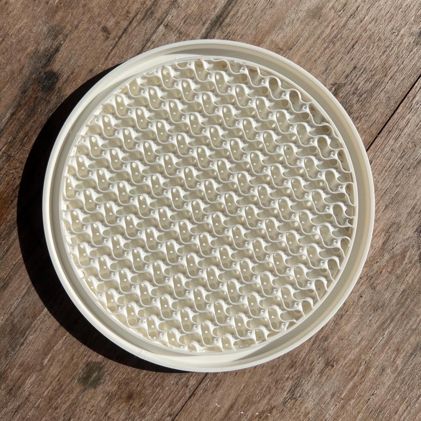 Top view of a gyroid pattern drip tray designed to collect excess water from plant pots