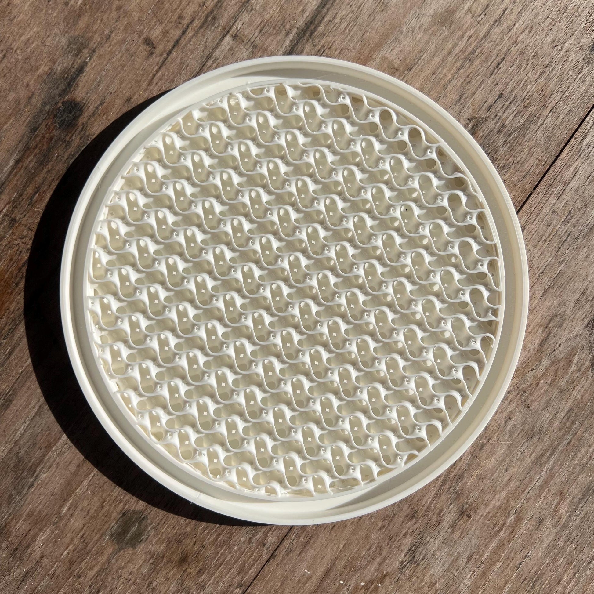 Top view of a gyroid pattern drip tray designed to collect excess water from plant pots