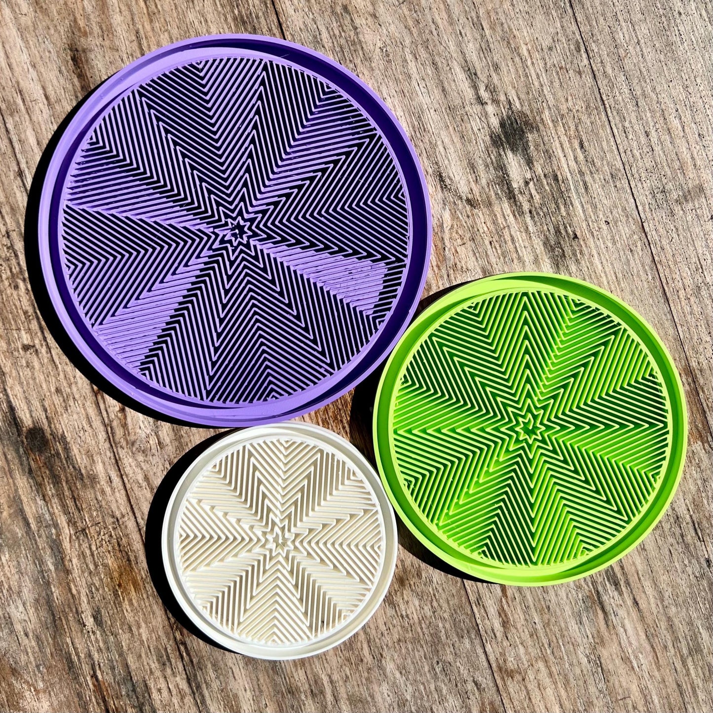 Star pattern drip trays shown in multiple colours, demonstrating available finish options