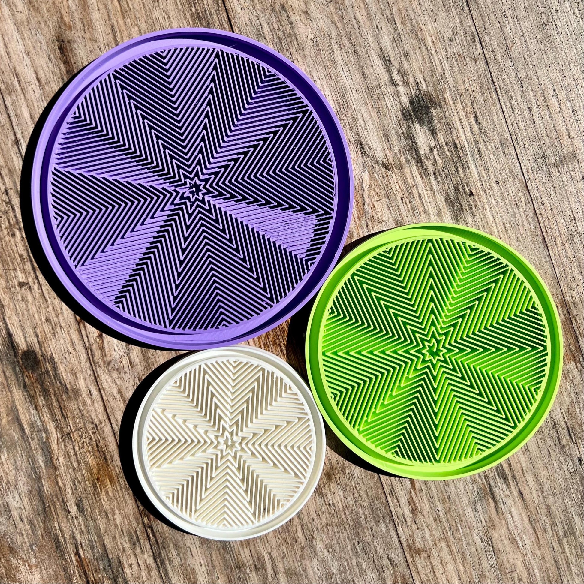 Star pattern drip trays shown in multiple colours, demonstrating available finish options